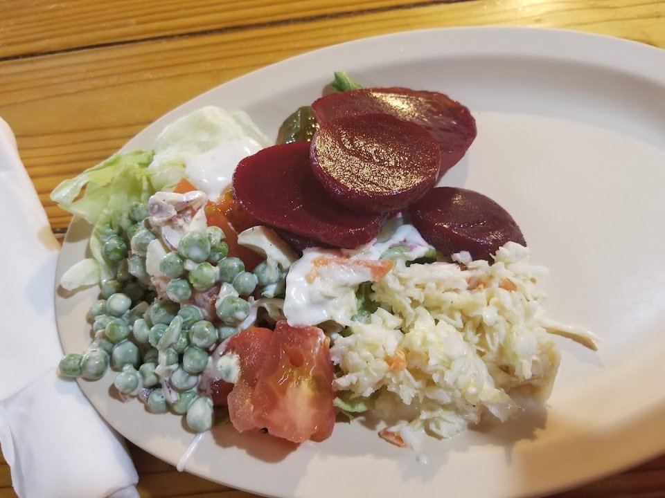 Burger and salad selections on a restaurant menu.